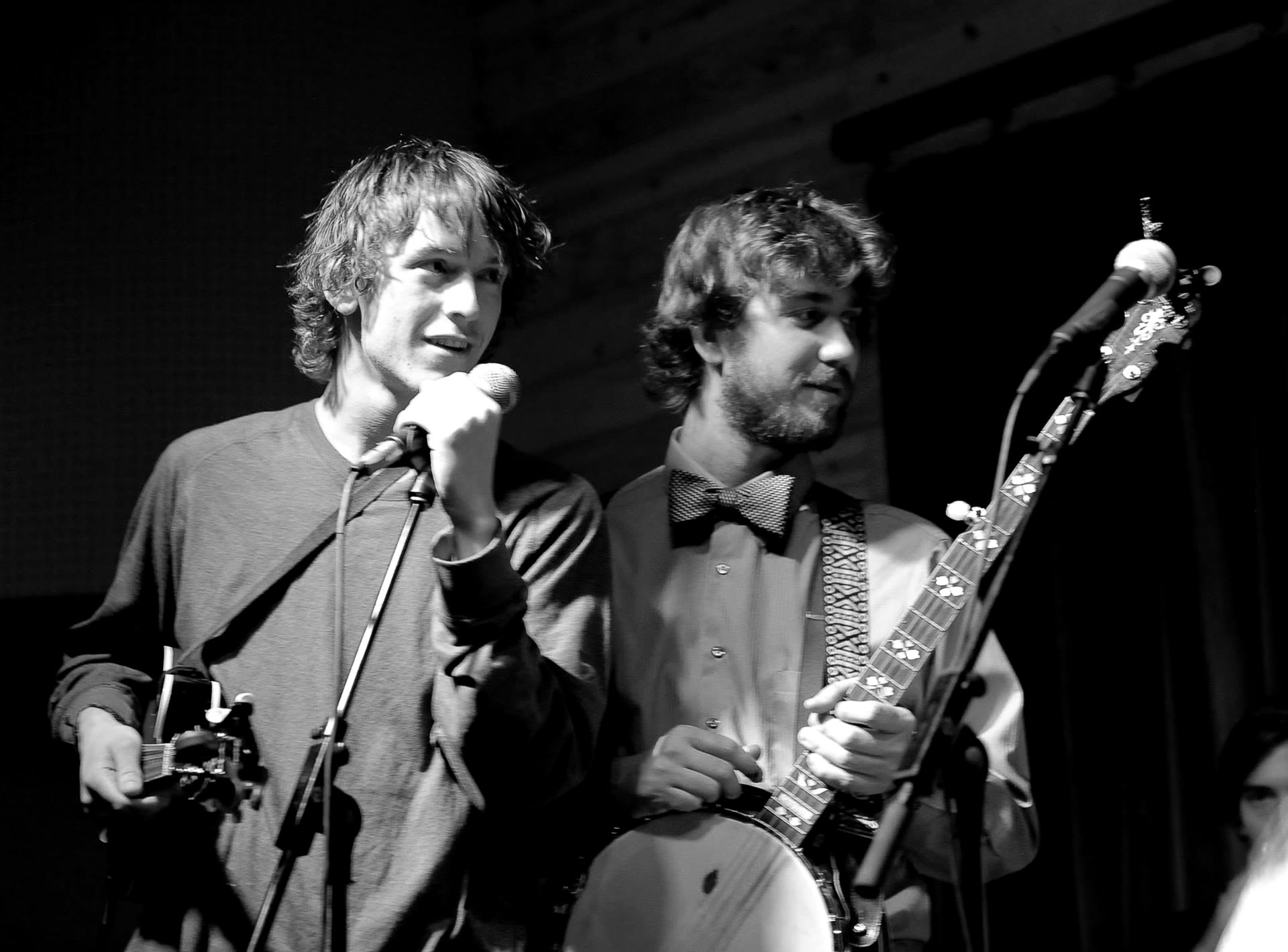Two performers singing at one microphone, Tyler Rice on banjo