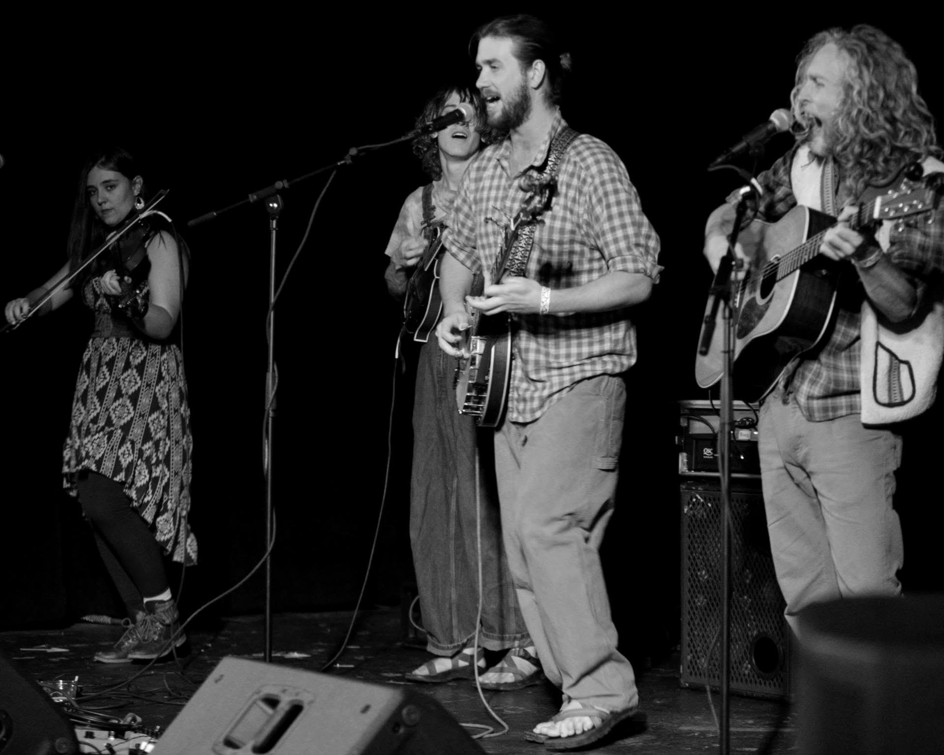 Band front line singing into microphones together