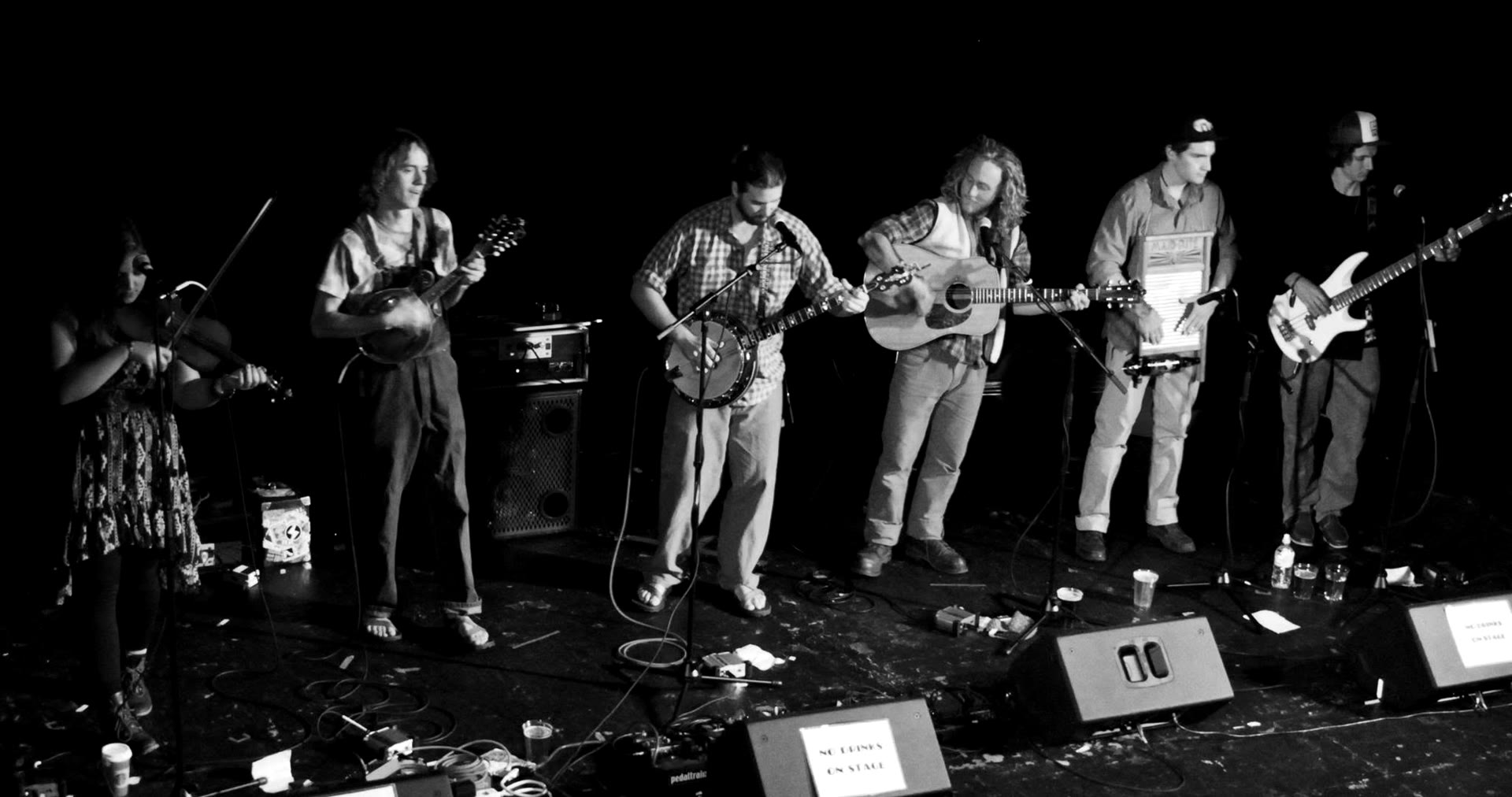 Six-piece band performing on a theatre stage