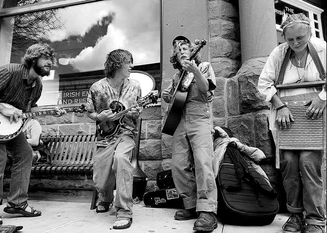 Street-busking string quartet on a Durango sidewalk, black and white